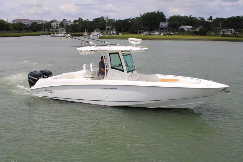 Slide: The Image of 2015 Boston Whaler 320 Outrage boat cruising on calm waters. - 0