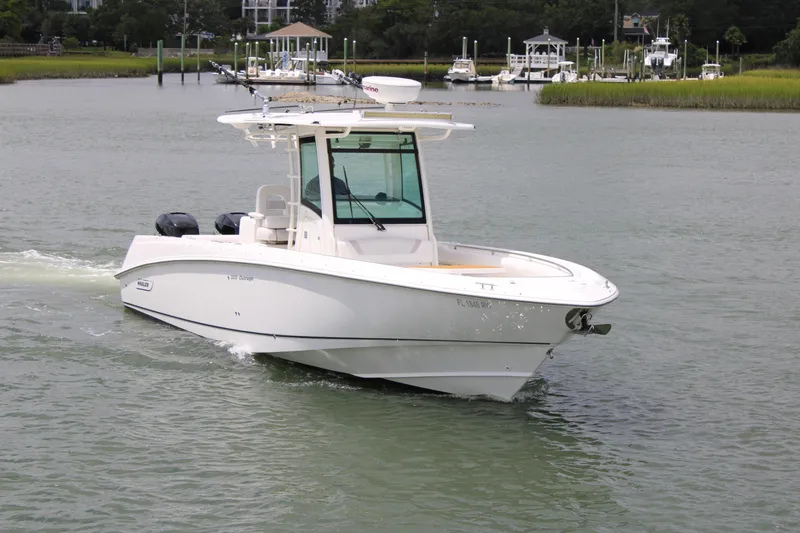 Slide: The Image of 2015 Boston Whaler 320 Outrage boat cruising on a calm waterway. - 14