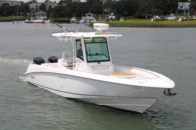 Slide: The Image of 2015 Boston Whaler 320 Outrage boat cruising on a calm waterway. - 15