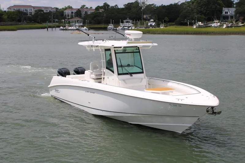 Slide: The Image of 2015 Boston Whaler 320 Outrage boat cruising on a calm waterway. - 16