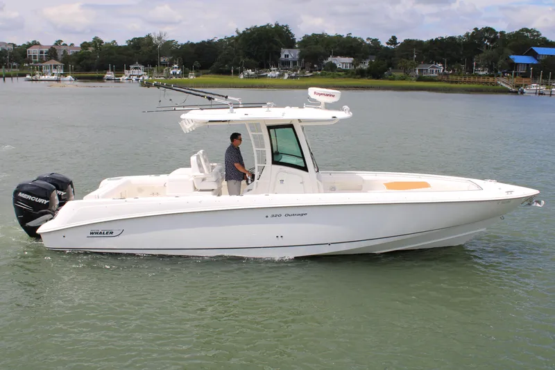 Slide: The Image of 2015 Boston Whaler 320 Outrage boat cruising on a calm waterway. - 17