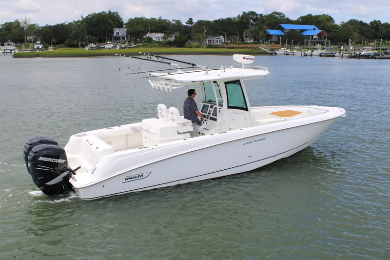 Slide: The Image of 2015 Boston Whaler 320 Outrage boat on water, featuring dual Mercury engines. - 18