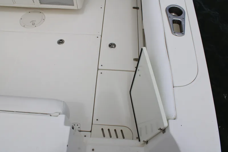 Slide: The Image of 2015 Boston Whaler 320 Outrage deck with open hatch and cup holder. - 19