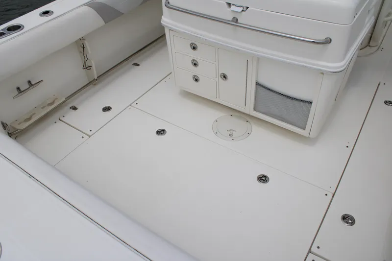 Slide: The Image of 2015 Boston Whaler 320 Outrage boat deck with storage compartments and seating. - 20