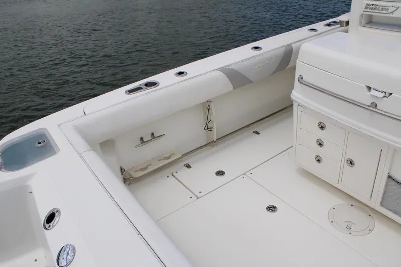 Slide: The Image of 2015 Boston Whaler 320 Outrage boat interior with storage compartments and seating. - 21