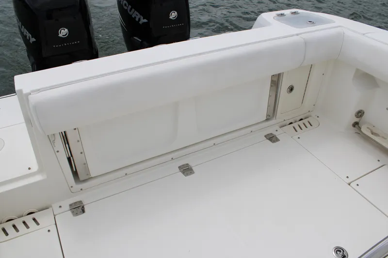 Slide: The Image of 2015 Boston Whaler 320 Outrage boat deck with seating and Mercury engines. - 23