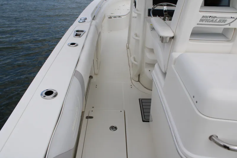 Slide: The Image of 2015 Boston Whaler 320 Outrage boat deck, showcasing sleek design and spacious layout. - 27