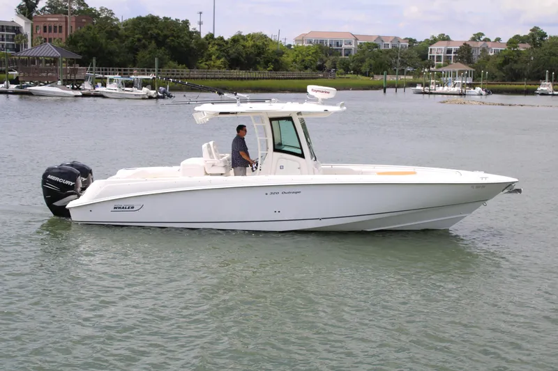 Slide: The Image of 2015 Boston Whaler 320 Outrage boat cruising on a calm waterway. - 3