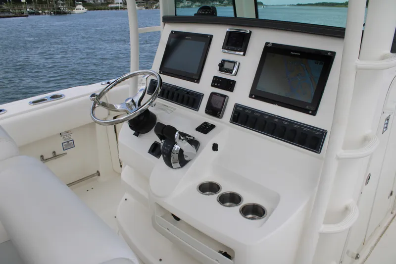 Slide: The Image of 2015 Boston Whaler 320 Outrage helm with dual displays and stainless steel steering wheel. - 34
