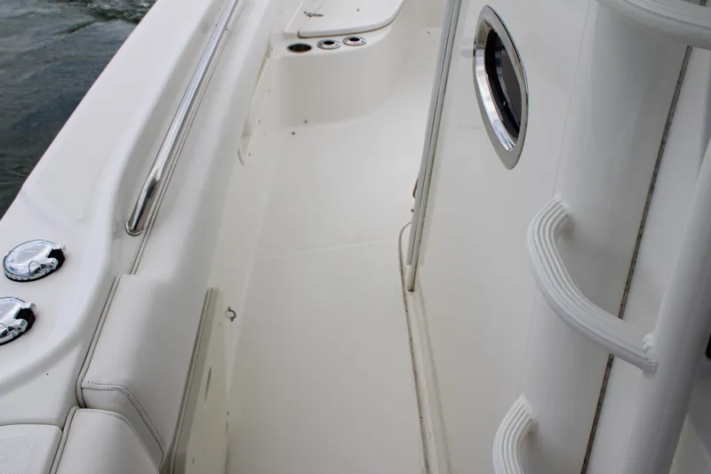 Slide: The Image of 2015 Boston Whaler 320 Outrage interior, featuring sleek white design and stainless steel accents. - 40