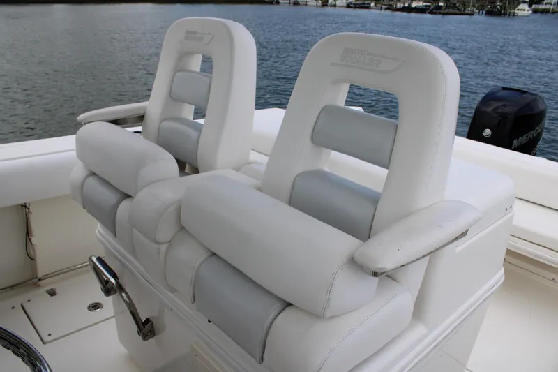 Slide: The Image of Luxury seating on 2015 Boston Whaler 320 Outrage boat, with water view. - 43