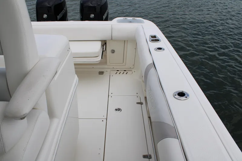 Slide: The Image of 2015 Boston Whaler 320 Outrage boat interior with seating and rod holders. - 46