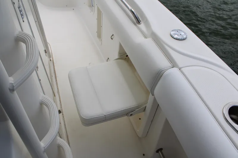 Slide: The Image of 2015 Boston Whaler 320 Outrage interior with foldable seat and cup holder. - 49