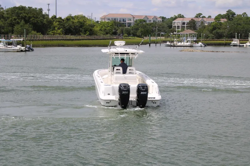Slide: The Image of 2015 Boston Whaler 320 Outrage boat cruising on a calm waterway. - 5
