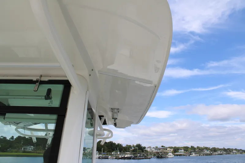 Slide: The Image of 2015 Boston Whaler 320 Outrage boat detail with blue sky background. - 51