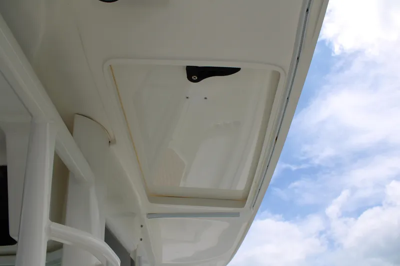 Slide: The Image of 2015 Boston Whaler 320 Outrage boat detail against a blue sky background. - 53