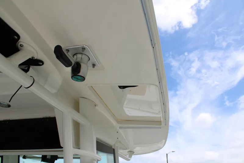 Slide: The Image of 2015 Boston Whaler 320 Outrage boat detail against a blue sky background. - 54
