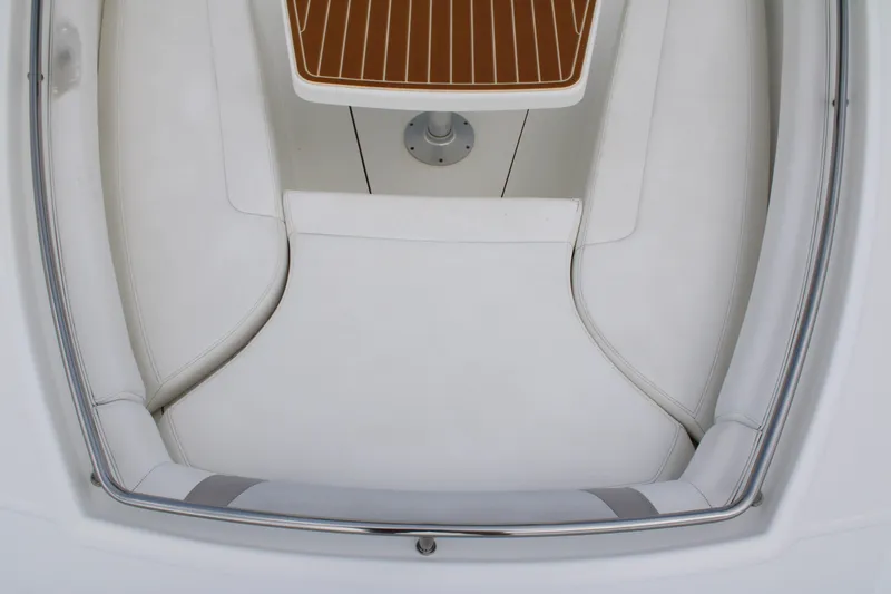 Slide: The Image of 2015 Boston Whaler 320 Outrage interior seating with white cushions and wooden accents. - 58