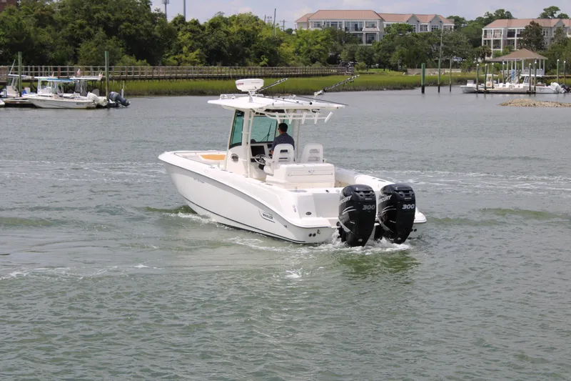 Slide: The Image of 2015 Boston Whaler 320 Outrage boat cruising on a calm river. - 6