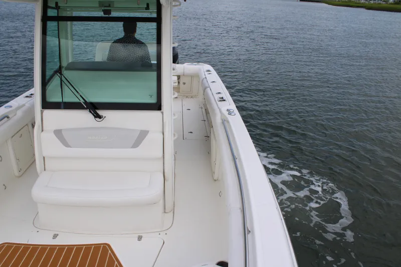 Slide: The Image of 2015 Boston Whaler 320 Outrage boat on water, rear view with seating and helm. - 62