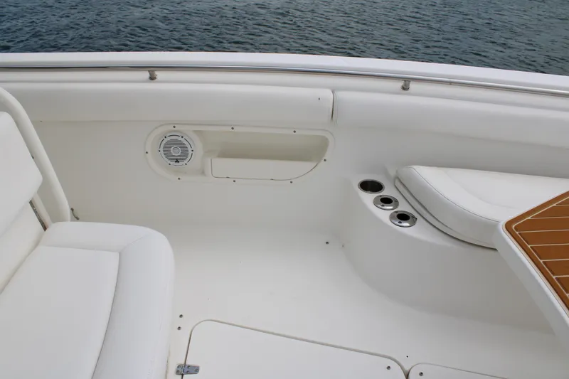 Slide: The Image of Interior view of a 2015 Boston Whaler 320 Outrage boat, featuring seating and cup holders. - 63