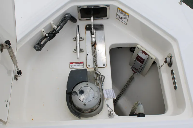 Slide: The Image of 2015 Boston Whaler 320 Outrage anchor locker with winch and control panel. - 65