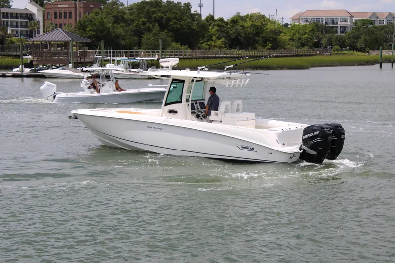 Slide: The Image of 2015 Boston Whaler 320 Outrage boat cruising on a calm waterway. - 7