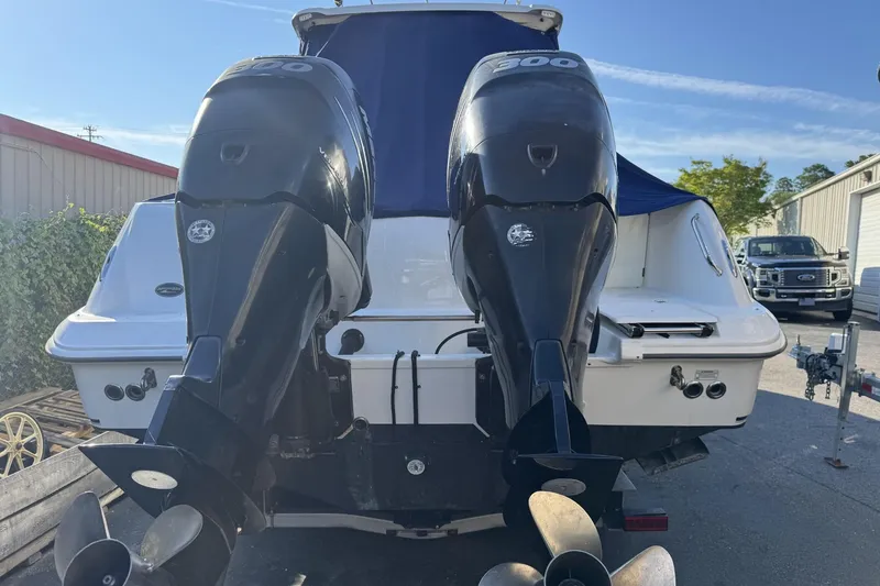 Slide: The Image of 2015 Boston Whaler 320 Outrage with dual outboard engines, docked outdoors. - 72
