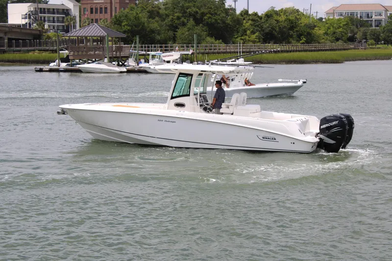 Slide: The Image of 2015 Boston Whaler 320 Outrage boat cruising on a scenic waterway. - 8