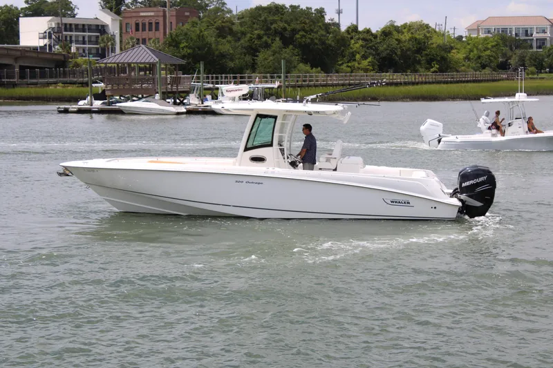 Slide: The Image of 2015 Boston Whaler 320 Outrage boat cruising on a calm river. - 9