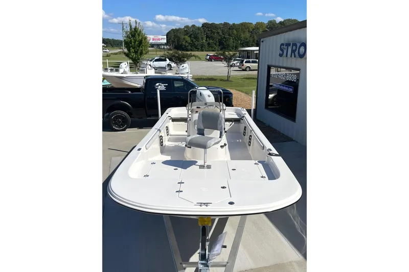 Slide: The Image of 2026 Carolina Skiff 21 LS boat displayed outdoors, showcasing spacious deck and seating. - 10