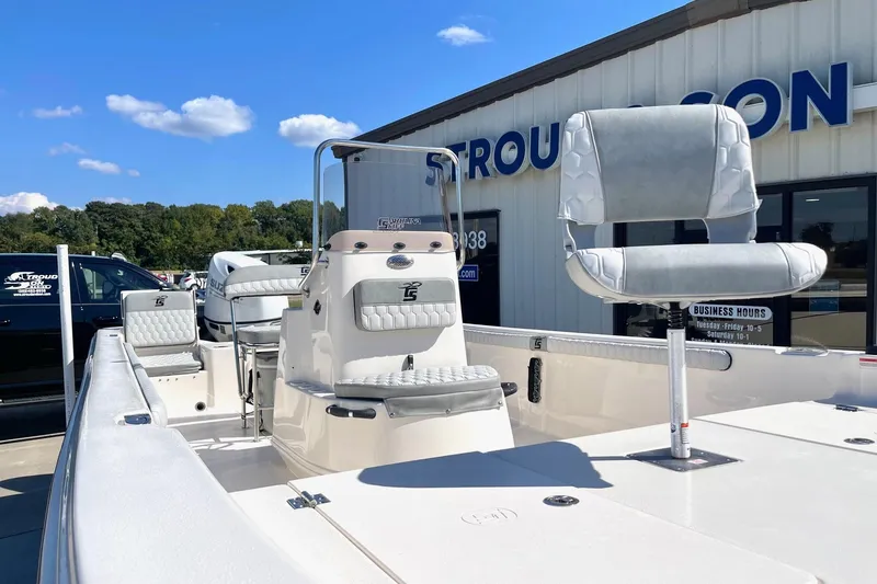 Slide: The Image of 2026 Carolina Skiff 21 LS boat with seating, displayed outdoors under clear skies. - 11