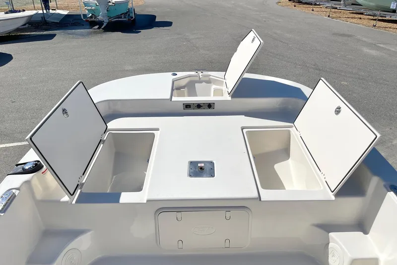 Slide: The Image of 2026 Carolina Skiff 21 LS boat with open storage compartments on deck. - 13