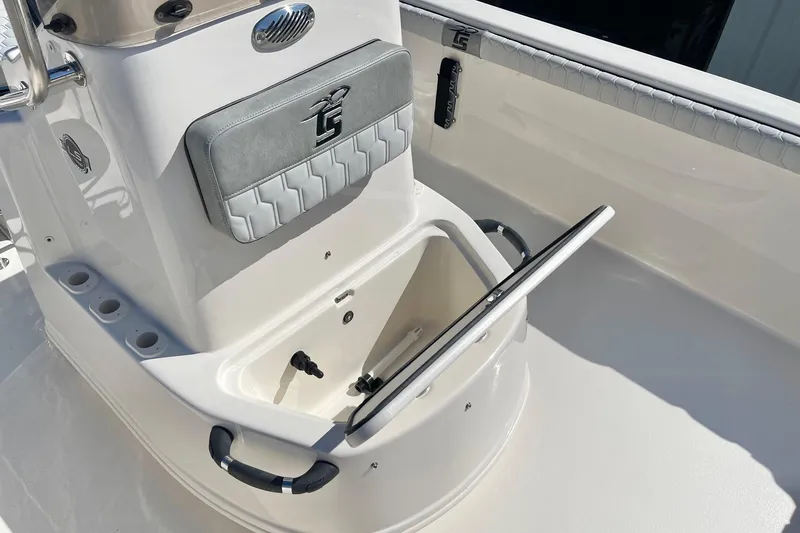 Slide: The Image of 2026 Carolina Skiff 21 LS boat interior with open storage compartment and cushioned seat. - 16