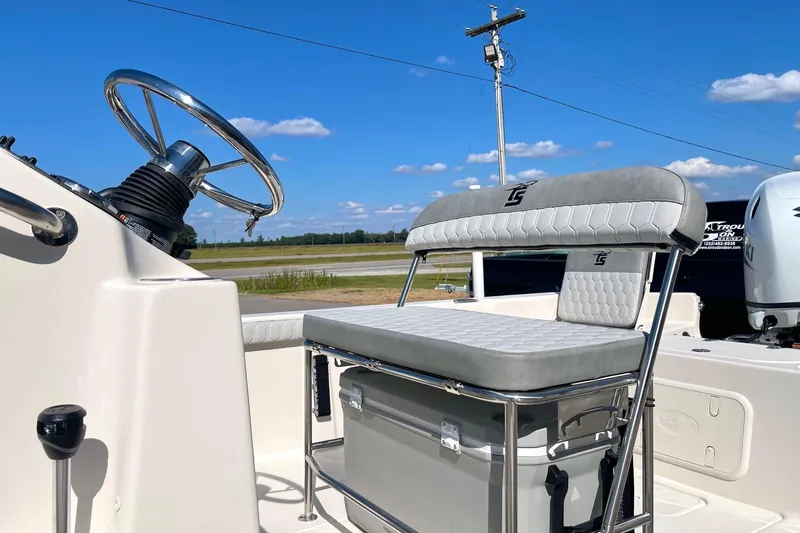 Slide: The Image of 2026 Carolina Skiff 21 LS boat interior with steering wheel and cushioned seating. - 17