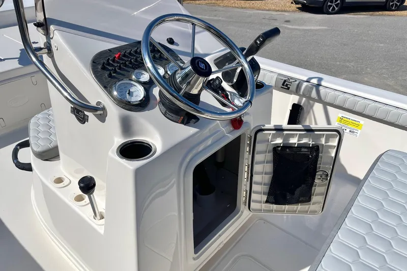 Slide: The Image of 2026 Carolina Skiff 21 LS boat console with steering wheel and gauges. - 19