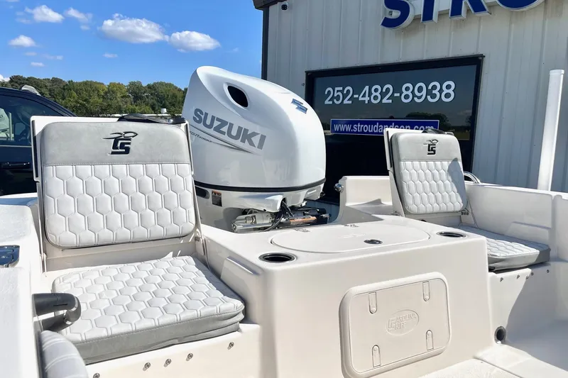 Slide: The Image of 2026 Carolina Skiff 21 LS boat with Suzuki engine, featuring comfortable seating and modern design. - 22