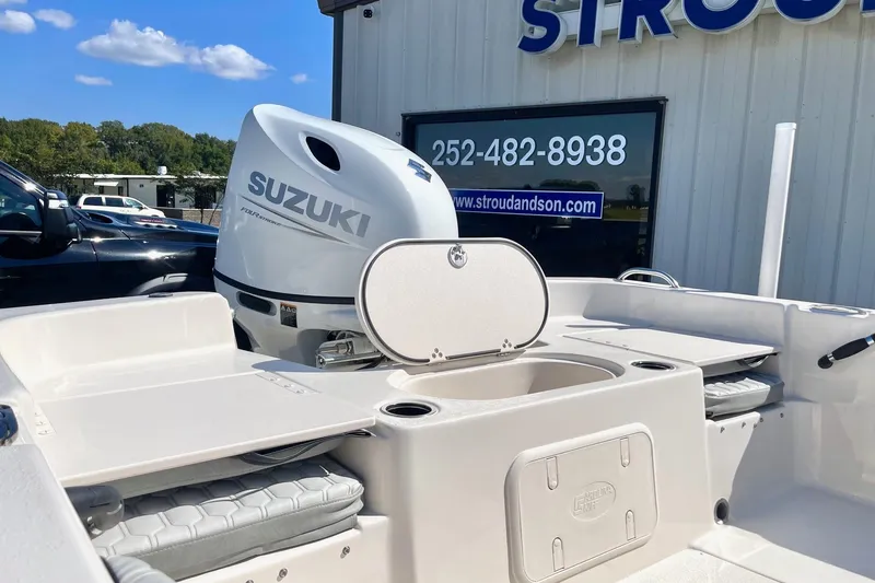 Slide: The Image of 2026 Carolina Skiff 21 LS boat with Suzuki outboard motor at dealership. - 24