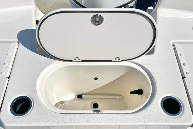 Slide: The Image of 2026 Carolina Skiff 21 LS boat livewell with open lid and cup holders. - 25