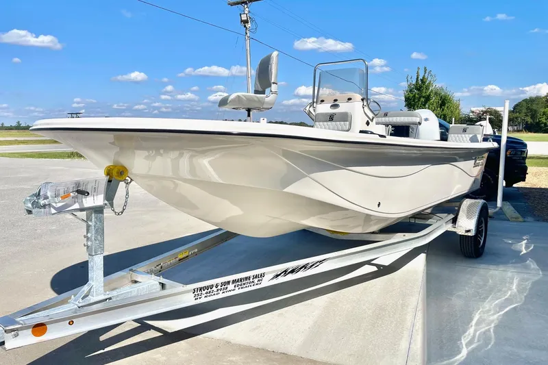 Slide: The Image of 2026 Carolina Skiff 21 LS boat on trailer under clear blue sky. - 4