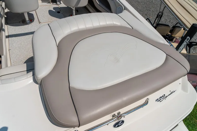Slide: The Image of 2002 Sea Ray 230 Bow Rider boat interior with cushioned seating and stylish design. - 10