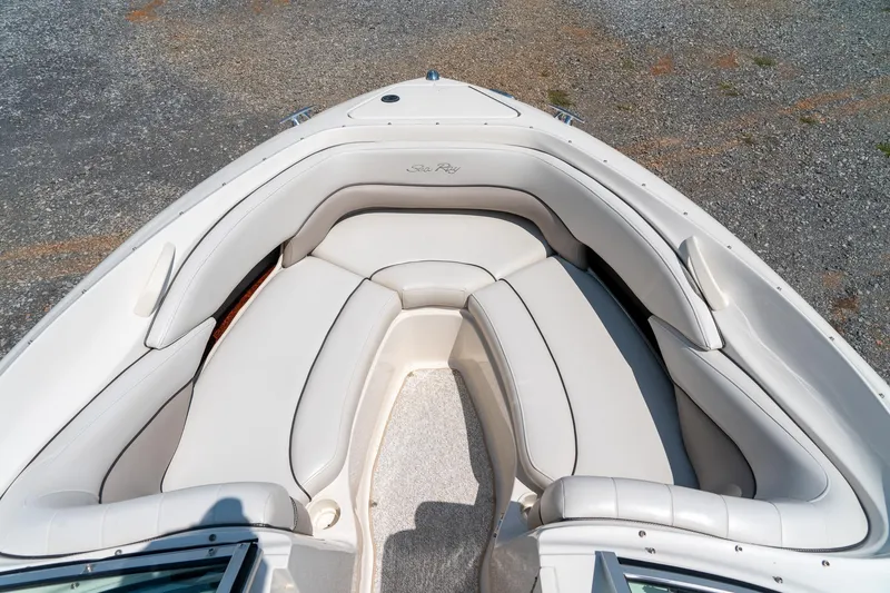 Slide: The Image of 2002 Sea Ray 230 Bow Rider boat with spacious, cushioned seating area. - 19