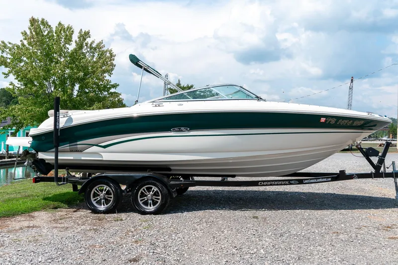 Slide: The Image of 2002 Sea Ray 230 Bow Rider boat on trailer, parked outdoors. - 2