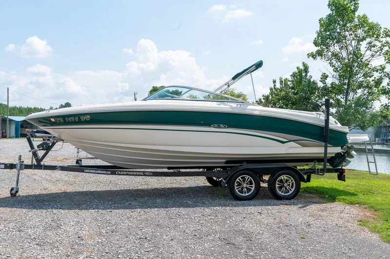 Slide: The Image of 2002 Sea Ray 230 Bow Rider boat on trailer, parked outdoors under a clear sky. - 6