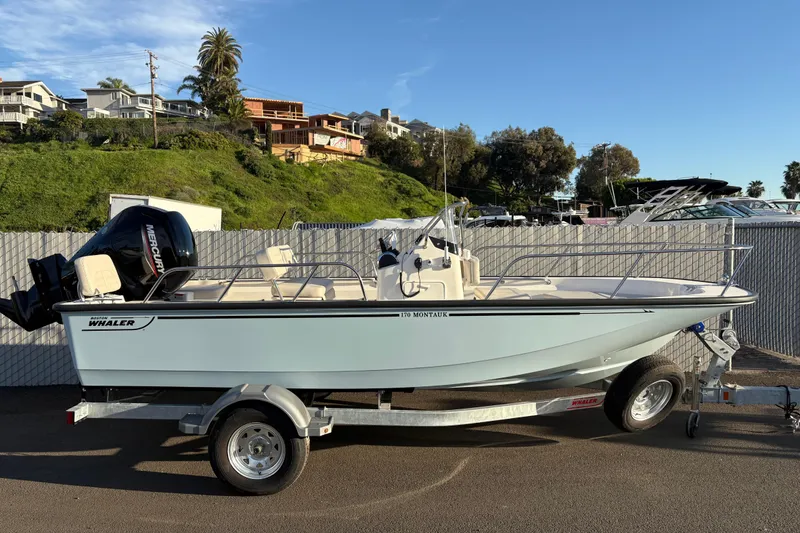 The Image of 2026 Boston Whaler 170 Montauk boat on trailer, parked outdoors. - 0