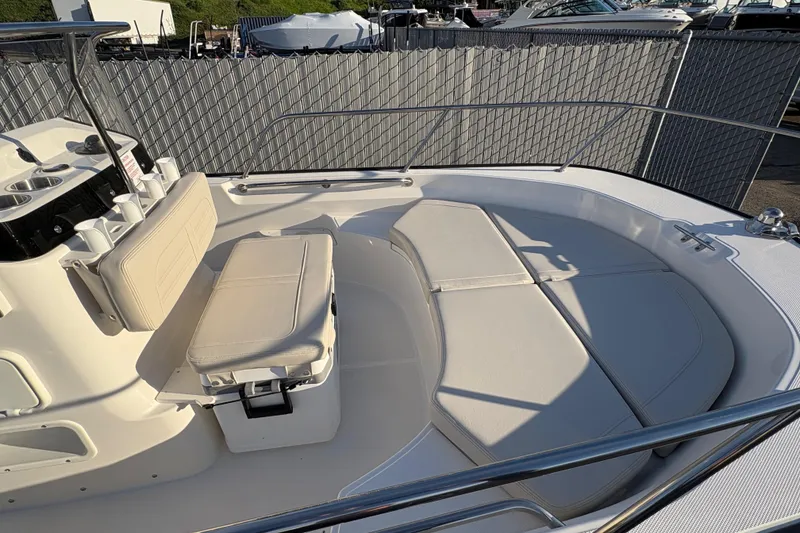 Slide: The Image of 2026 Boston Whaler 170 Montauk boat interior with cushioned seating and storage. - 2
