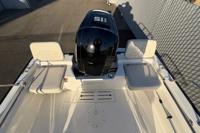 Slide: The Image of 2026 Boston Whaler 170 Montauk boat interior with seating and engine view. - 4