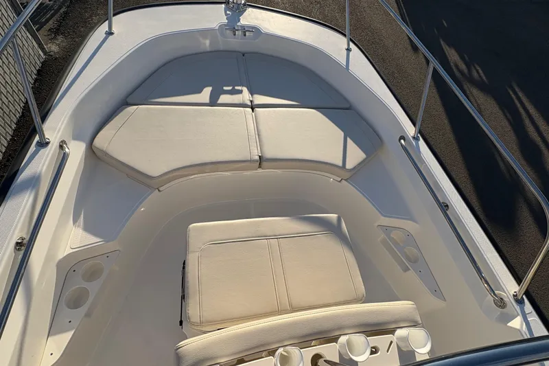 Slide: The Image of 2026 Boston Whaler 170 Montauk boat interior with cushioned seating and cup holders. - 7