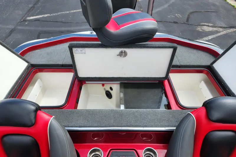 Slide: The Image of 2015 Ranger Z521 Comanche boat interior with open storage compartments and red-black seating. - 8