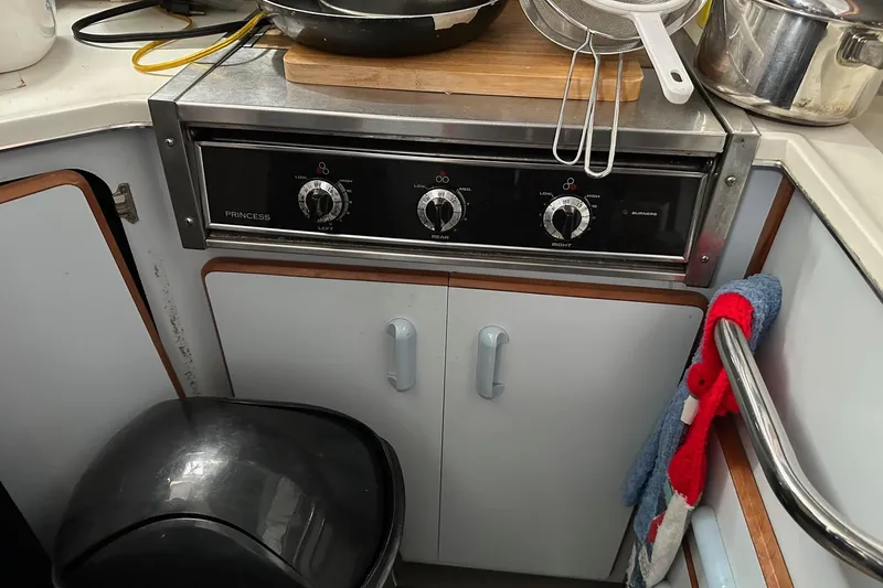 Slide: The Image of Galley kitchen in 1989 Sea Ray 380 Aft Cabin with stove and cookware. - 11